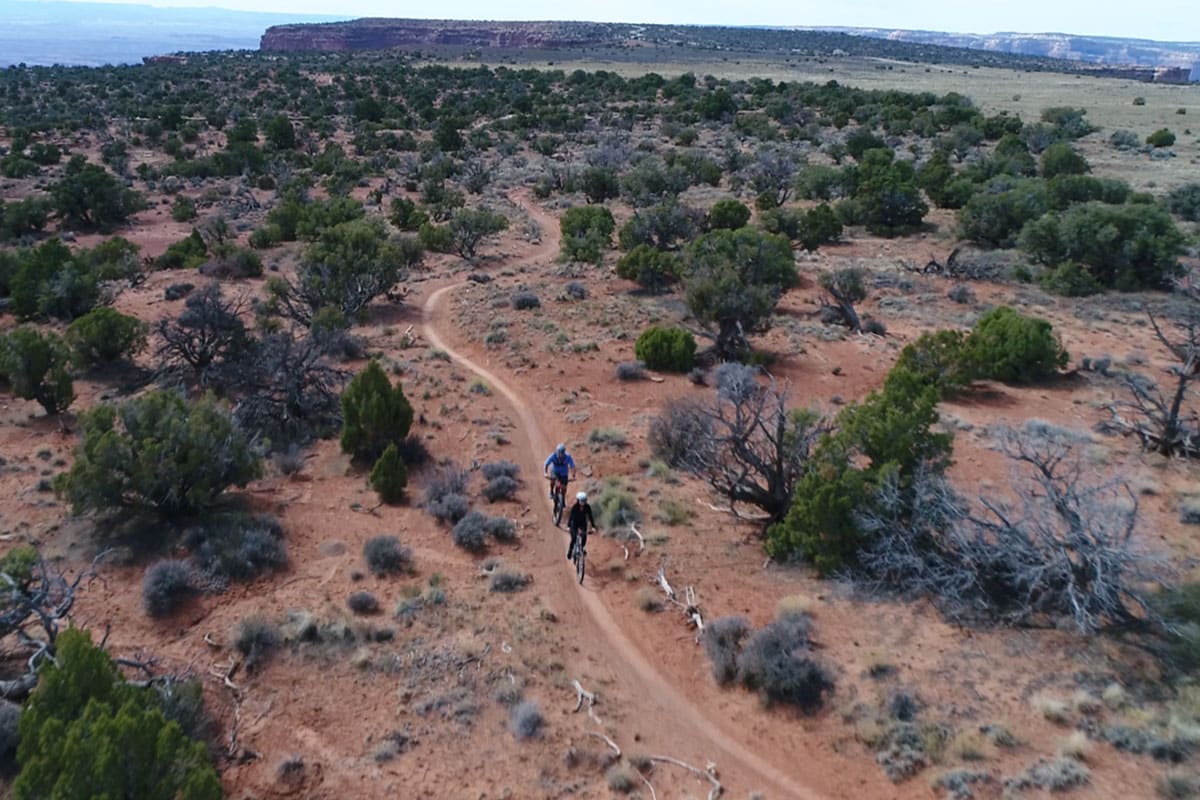 Guys Cycling at Dead Horse Point State Park overlook, Utah.